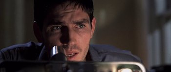Movie still from “Frequency” (2000), directed by Gregory Hoblit – A person looking at the camera; Close Up shot, Over the shoulder angle