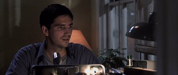 Movie still from “Frequency” (2000), directed by Gregory Hoblit – A man sitting in front of a mirror in a room; Close Up shot, Over the shoulder angle