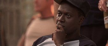 Movie still from “Frequency” (2000), directed by Gregory Hoblit – A person with his hand under his chin; Close Up shot, High angle