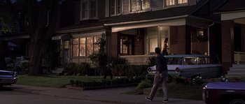 Movie still from “Frequency” (2000), directed by Gregory Hoblit – A man walking down a street at night; Wide shot, Over the shoulder angle