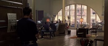 Movie still from “Frequency” (2000), directed by Gregory Hoblit – A group of people sitting around a living room watching television; Wide shot, High angle