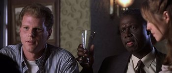 Movie still from “Frequency” (2000), directed by Gregory Hoblit – Two people holding a glass of water in a dark room; Close Up shot, Low angle