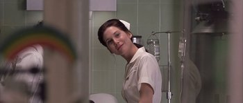 Movie still from “Frequency” (2000), directed by Gregory Hoblit – A woman in a white uniform standing next to a sink; Close Up shot, Low angle