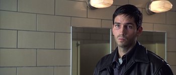 Movie still from “Frequency” (2000), directed by Gregory Hoblit – A man standing in front of a bathroom mirror; Close Up shot, Over the shoulder angle