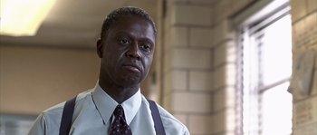 Movie still from “Frequency” (2000), directed by Gregory Hoblit – A man in a white dress shirt and a tie; Close Up shot, Low angle