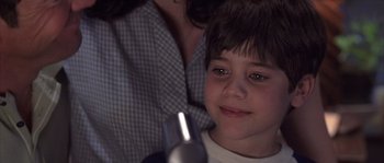 Movie still from “Frequency” (2000), directed by Gregory Hoblit – A person and a child with a microphone; Close Up shot, Over the shoulder angle