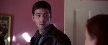 Movie still from “Frequency” (2000), directed by Gregory Hoblit – A person wearing a suit and tie; Close Up shot, Over the shoulder angle