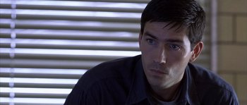 Movie still from “Frequency” (2000), directed by Gregory Hoblit – A person sitting in front of a window; Close Up shot, Over the shoulder angle