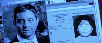 Movie still from “Frequency” (2000), directed by Gregory Hoblit – An old photo of a man with a gun in his hand; Extreme Close Up shot, High angle