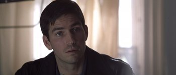 Movie still from “Frequency” (2000), directed by Gregory Hoblit – A person wearing a leather jacket; Close Up shot, Over the shoulder angle