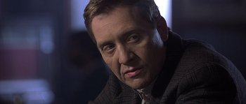 Movie still from “Frequency” (2000), directed by Gregory Hoblit – A person wearing a suit and tie; Close Up shot, Over the shoulder angle