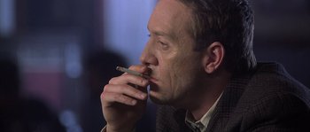 Movie still from “Frequency” (2000), directed by Gregory Hoblit – A person smoking a cigarette; Close Up shot, Low angle