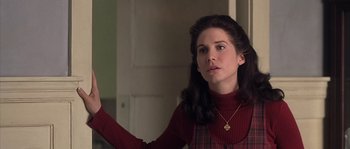 Movie still from “Frequency” (2000), directed by Gregory Hoblit – A woman in a red sweater is holding her hand up; Close Up shot, Over the shoulder angle