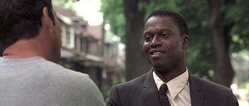 Movie still from “Frequency” (2000), directed by Gregory Hoblit – A person wearing a suit and tie; Close Up shot, Over the shoulder angle