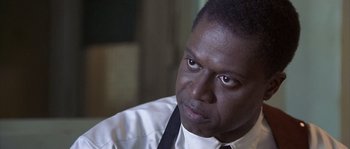 Movie still from “Frequency” (2000), directed by Gregory Hoblit – A person wearing a shirt and tie; Close Up shot, Low angle