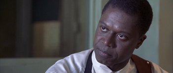 Movie still from “Frequency” (2000), directed by Gregory Hoblit – A person wearing a shirt and tie; Close Up shot, Over the shoulder angle