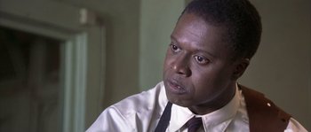 Movie still from “Frequency” (2000), directed by Gregory Hoblit – A person wearing a shirt and a tie; Close Up shot, Low angle