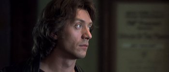 Movie still from “Frequency” (2000), directed by Gregory Hoblit – A person with long brown hair; Close Up shot, Low angle