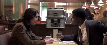 Movie still from “Frequency” (2000), directed by Gregory Hoblit – A man and a woman sitting at a table; Medium shot, Over the shoulder angle