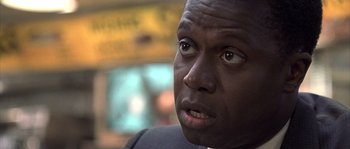 Movie still from “Frequency” (2000), directed by Gregory Hoblit – A man's face in a suit jacket; Close Up shot, Over the shoulder angle