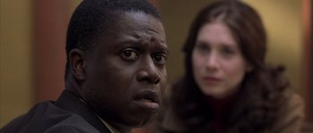 Movie still from “Frequency” (2000), directed by Gregory Hoblit – A person looking at the camera; Close Up shot, Over the shoulder angle