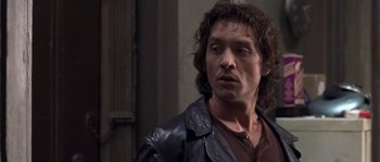 Movie still from “Frequency” (2000), directed by Gregory Hoblit – A person wearing a leather jacket; Close Up shot, Over the shoulder angle