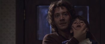 Movie still from “Frequency” (2000), directed by Gregory Hoblit – A person with long curly hair; Close Up shot, Over the shoulder angle