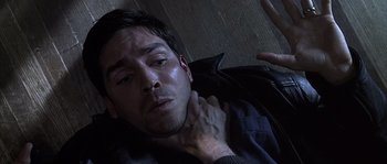 Movie still from “Frequency” (2000), directed by Gregory Hoblit – A man laying on the ground with his eyes closed; Close Up shot, Overhead angle