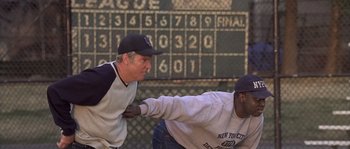 Movie still from “Frequency” (2000), directed by Gregory Hoblit – Two baseball players are playing a game of baseball; Medium shot, Over the shoulder angle