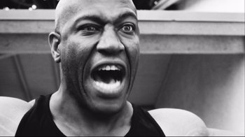 Movie still from “Friday” (1995), directed by F. Gary Gray – A black and white photo of a man with a mouth open; Close Up shot, Low angle