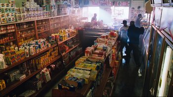 Movie still from “Friday” (1995), directed by F. Gary Gray – A store filled with lots of food on the shelves; Wide shot, High angle