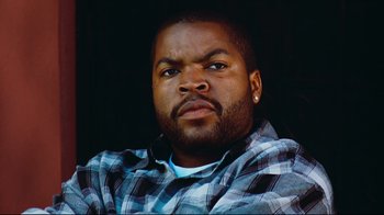 Movie still from “Friday” (1995), directed by F. Gary Gray – A person wearing a plaid shirt; Close Up shot, Low angle