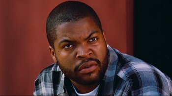 Movie still from “Friday” (1995), directed by F. Gary Gray – A person wearing a plaid shirt; Close Up shot, Low angle