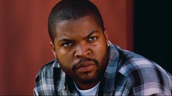 Movie still from “Friday” (1995), directed by F. Gary Gray – A person wearing a plaid shirt; Close Up shot, Low angle