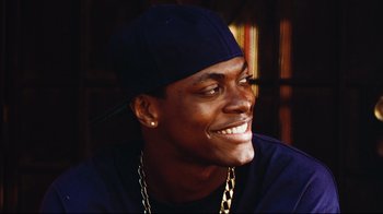 Movie still from “Friday” (1995), directed by F. Gary Gray – A person wearing a hat; Close Up shot, Over the shoulder angle