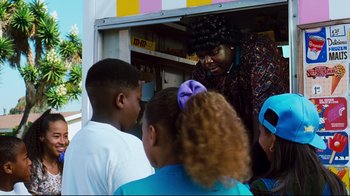 Movie still from “Friday” (1995), directed by F. Gary Gray – A group of people standing around a food truck; Medium shot, Over the shoulder angle