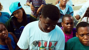 Movie still from “Friday” (1995), directed by F. Gary Gray – A group of young people standing around each other; Close Up shot, High angle