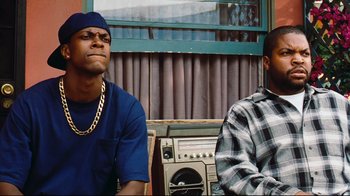 Movie still from “Friday” (1995), directed by F. Gary Gray – Two men sitting next to each other in front of a radio; Close Up shot, Low angle