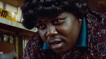 Movie still from “Friday” (1995), directed by F. Gary Gray – A person wearing a shirt; Close Up shot, Low angle