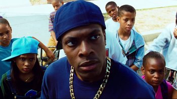Movie still from “Friday” (1995), directed by F. Gary Gray – A group of young men standing next to each other; Close Up shot, Over the shoulder angle