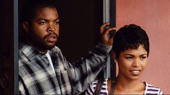 Movie still from “Friday” (1995), directed by F. Gary Gray – A man and a woman standing next to each other; Close Up shot, Over the shoulder angle
