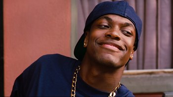 Movie still from “Friday” (1995), directed by F. Gary Gray – A person wearing a hat and smiling; Close Up shot, Low angle