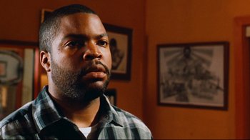 Movie still from “Friday” (1995), directed by F. Gary Gray – A person wearing a plaid shirt; Close Up shot, Over the shoulder angle