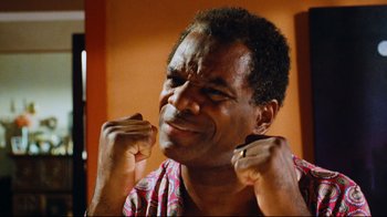 Movie still from “Friday” (1995), directed by F. Gary Gray – An older man with his hands up in the air; Close Up shot, Low angle