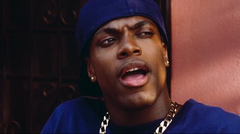 Movie still from “Friday” (1995), directed by F. Gary Gray – A person wearing a hat; Close Up shot, Over the shoulder angle