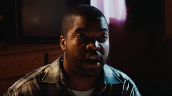 Movie still from “Friday” (1995), directed by F. Gary Gray – A person with his mouth wide open; Close Up shot, Over the shoulder angle