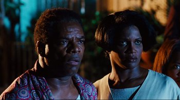 Movie still from “Friday” (1995), directed by F. Gary Gray – A man and a woman standing next to each other; Close Up shot, Low angle