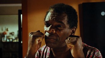 Movie still from “Friday” (1995), directed by F. Gary Gray – A person holding his hands up; Close Up shot, Low angle