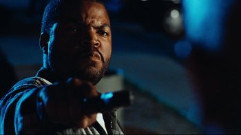 Movie still from “Friday” (1995), directed by F. Gary Gray – A man holding a hammer in his hand; Close Up shot, Low angle