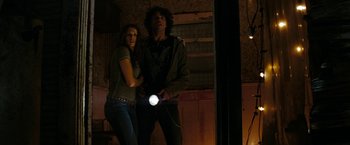 Movie still from “Friday the 13th” (2009), directed by Marcus Nispel – A man and a woman are holding a flashlight in the dark; Medium shot, Low angle